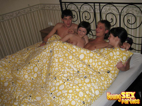 Horny teenagers swap girlfriends during a foursome on a bed - #1109276