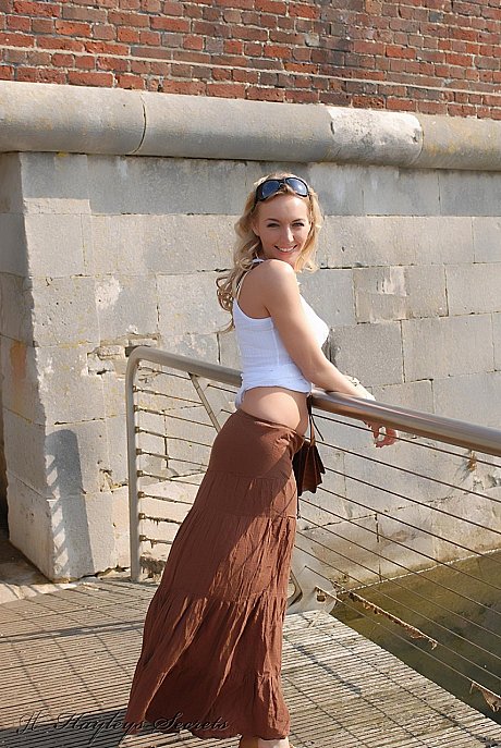 Solo chick girlfriend woman Hayley Marie Coppin flashes her bare ass while walking on sidewalk