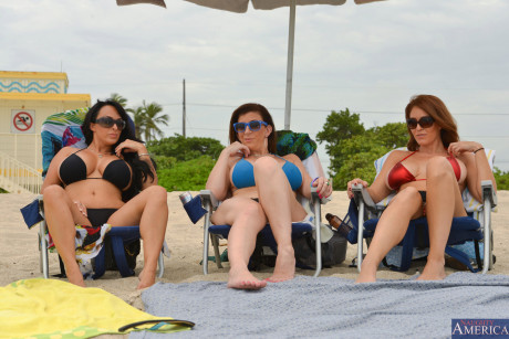 Three busty beach babes pull aside bikini tops to flaunt humongous melons by the water - #1168102