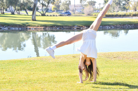 Brunette amateur Dakota does a cartwheel in a park before getting nude - #416593
