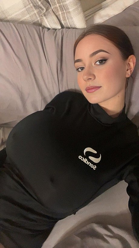 Adorable blue eyed teen with giant juggs Brooke Mills poses in a tight shirt