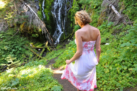 Beautiful cute Delia by waterfall erect under her dress