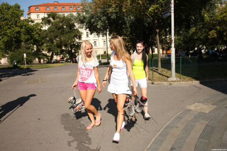 Four pretty teens expose their petite bodies and small titties on roller blades