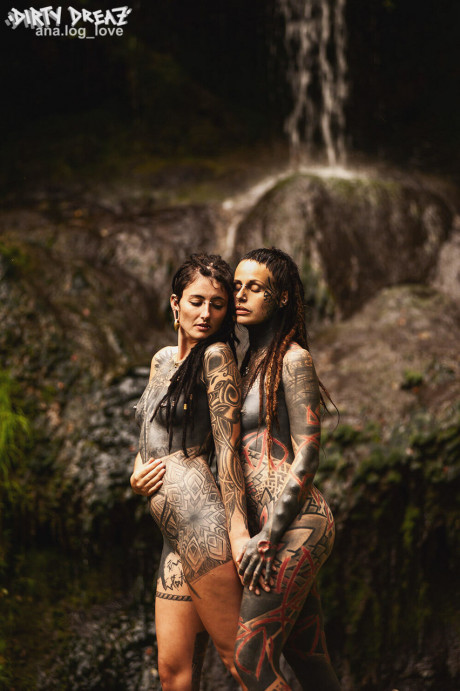 Heavily tattooed lesbians hold each other while totally naked on a bridge - #347736