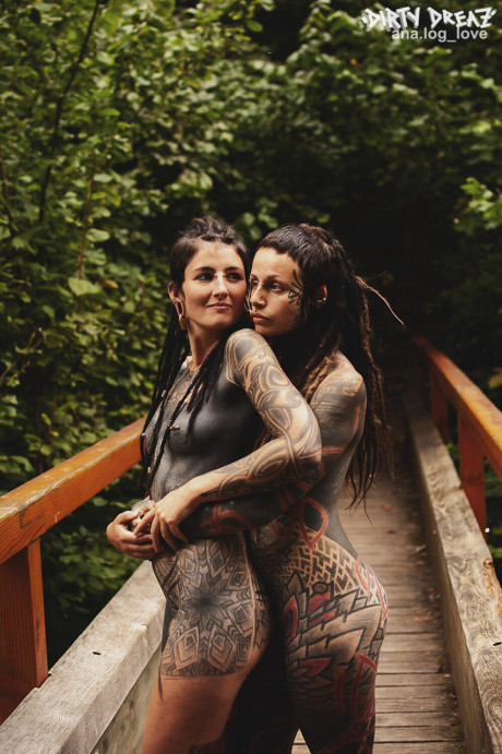 Heavily tattooed lesbians hold each other while totally naked on a bridge - #347737
