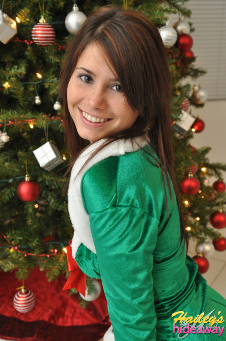 Amateur Xmas elf Hailey lifts her tight skirt to show her fine butt by the tree - #987991