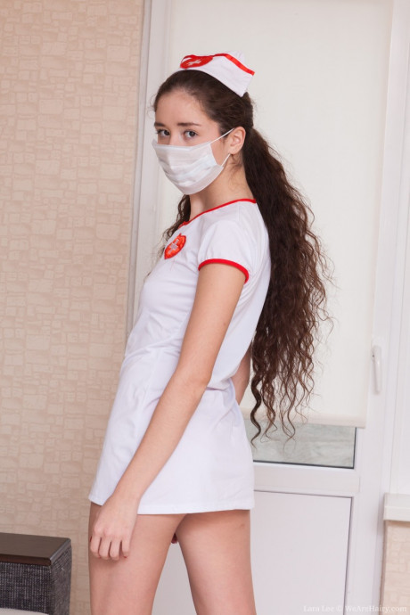 Long-haired nurse Lara Lee strips undressed to play with her inviting furry snatch - #189342