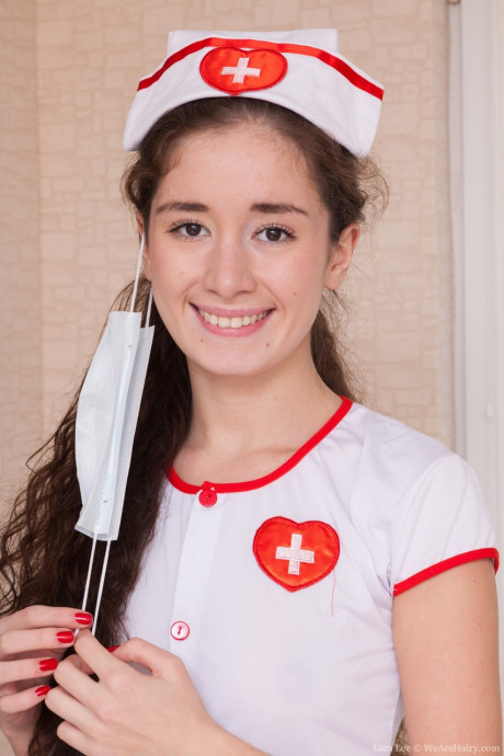 Long-haired nurse Lara Lee strips undressed to play with her inviting furry snatch - #189343