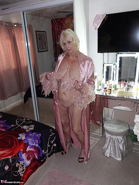 Yellow-haired grandma Sparkle exposes her saggy titties and shaved twat in a satin robe - Image 5 of 16  in Pussy category   featuring Sparkle 