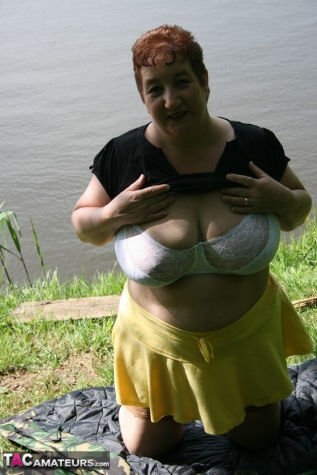Older redhead wild Carol exposes her bra and underwear near the water - #116854