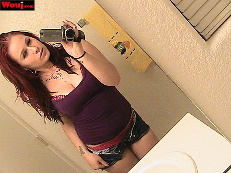 Redheaded amateur babe WouJ teases with her hot cleavage in the mirror - Image 1 of 15  in Babe category   featuring Mia Rosette 
