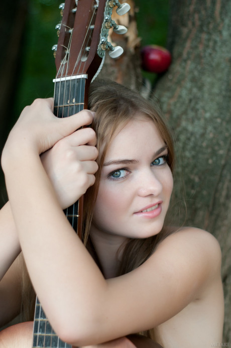 Absolutely ravishing teenie Bridgit A poses undressed with a guitar outdoors - #900186
