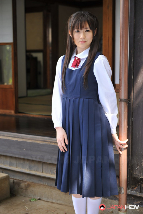 Charming Japanese babe posing in her attractive school outfit in the garden