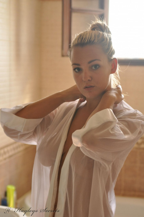 Beautiful blondy slut girl Jodie Gasson pulls on a see thru blouse in the morning