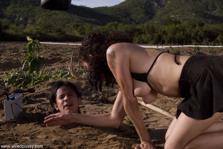 Buried babe Nadia Styles gets shocked by a kinky curly-haired female