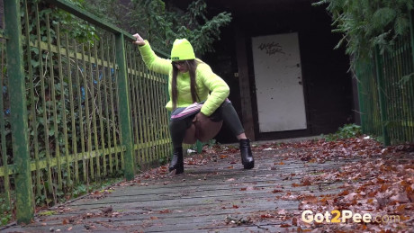 Solo whore gf woman Barbara Bieber pees on leaf strewn boards on a grey day - #1122845