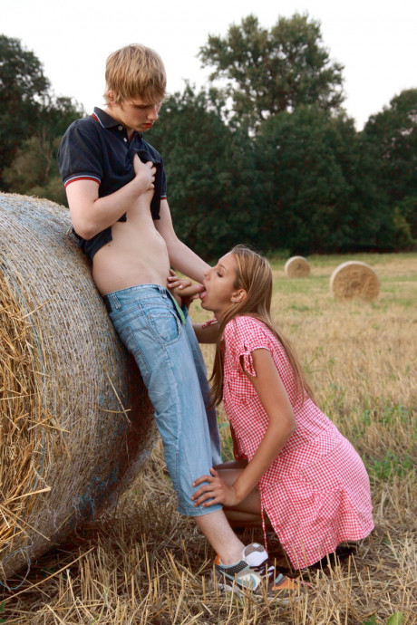 Horny young young couple have sexual intercourse against a round bale in a field - #180163