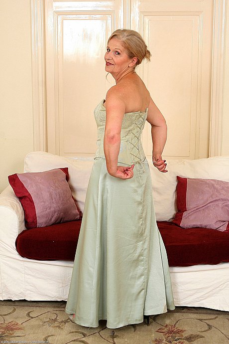 Dirty grandmother Nelli loses her dress and flaunts her pussy on a couch - Image 6 of 20  in Legs category   featuring Nelli 