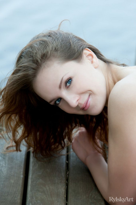 Euro model Ilze wears a smile on beautiful fine face during nude posing on dock - #336683