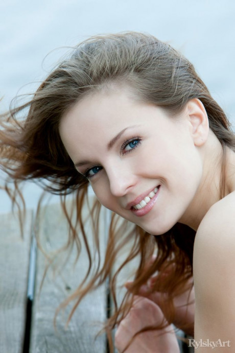 Euro model Ilze wears a smile on beautiful fine face during nude posing on dock - #336687