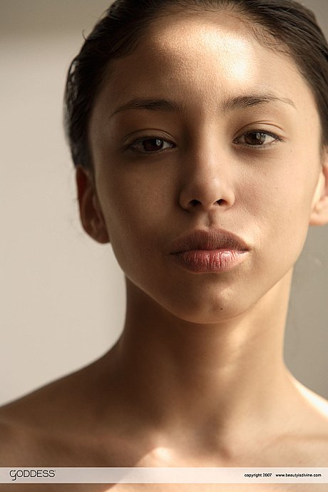 Petite teen Alexis thrusts her perky tits forth in front of a mirror