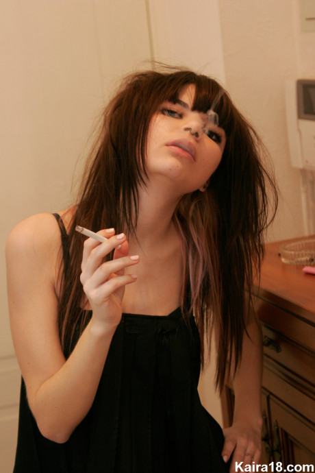 Skinny young Kaira 18 smokes a cigarette while getting naked in her bedroom - #41903
