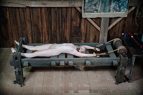 Blondy female Delirious Hunter is restrained in a variety of ways