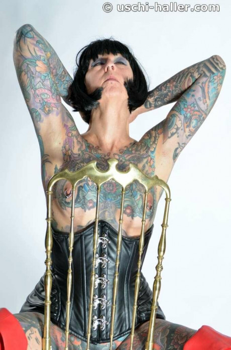 Solo skank gf woman Tattoogirl Cleo gets nude in a leather waist cincher and long boots