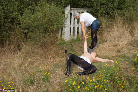 Older British chick restrains busty old skank girl Speedy Bee while in the outdoors - #780374