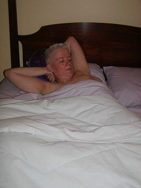 Older skank woman with short yellow-haired hair Tiffany Pearl gets undressed upon a bed - Image 11 of 16  in Pussy category   featuring Tiffany Pearl 