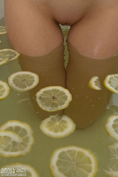 Sexy blondie teenie sinks her bald snatch into a tub filled with lemon slices - Image 4 of 20  in Pussy category   featuring Vera 