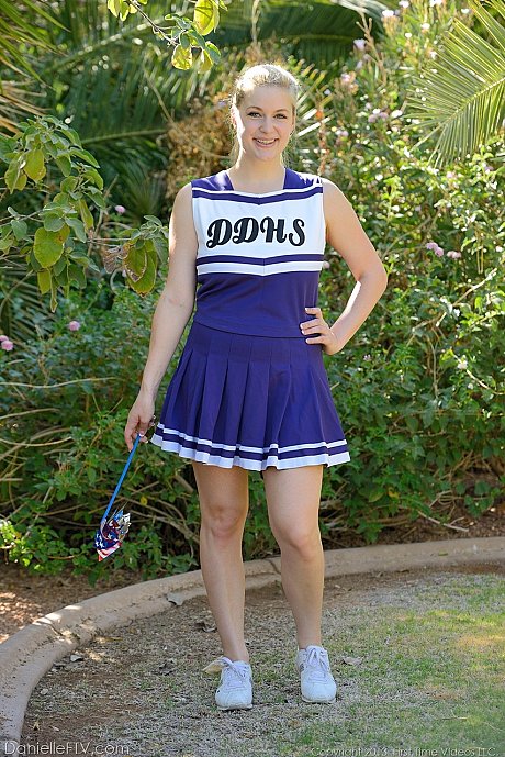 Cheerleader Danielle playfully shows breasts and vagina without taking uniform off