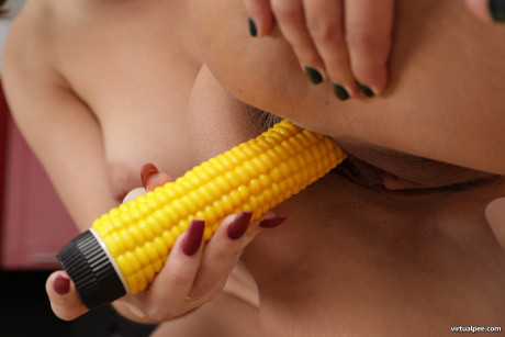 Lesbians Eva Brown & Moona expose their big boobs & play with a corn-shaped toy