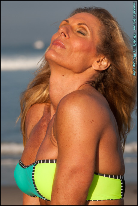 Female bodybuilder Kimberly Dickson poses in a bikini while at the beach - #292353