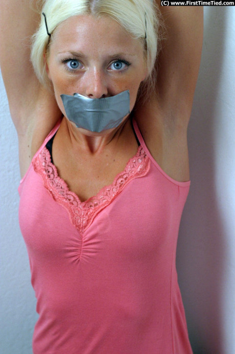 Clothed yellow-haired is shut up with duct over mouth and wrists tied together - #283489
