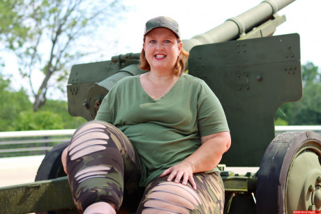 Obese amateur Goddess Pear models for a SFW shoot on an artillery gun in camo