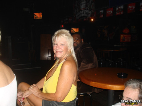 Blonde amateur cougar shows her shaved clam in the swinger night club