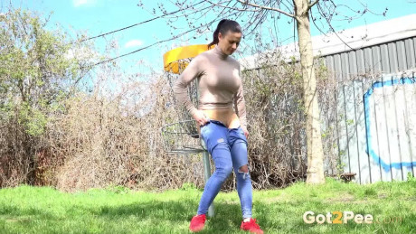 Billie Star squats in the grass to piss outside - #458405