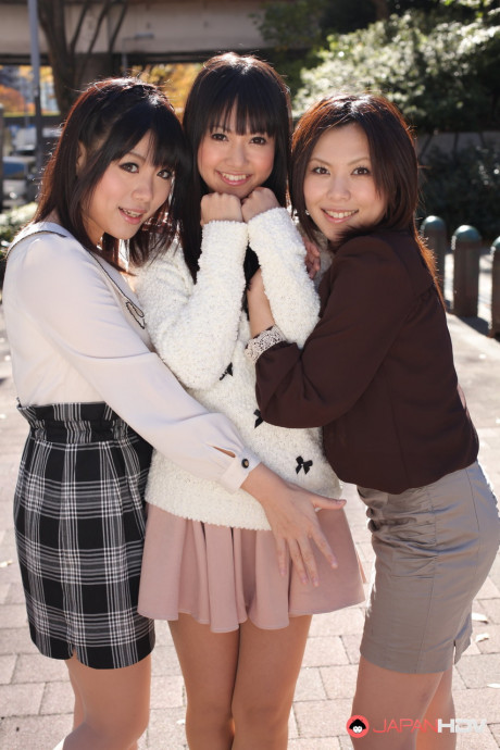 Three Japanese bitches in skirts pose outdoors for a SFW shoot