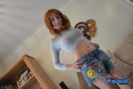 Redheaded vixen strips her clothes off and gives a perverted nerd a blowjob - #1197916