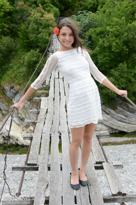 Skinny teen wears a flower in her hair while posing nude on suspension bridge - #81891