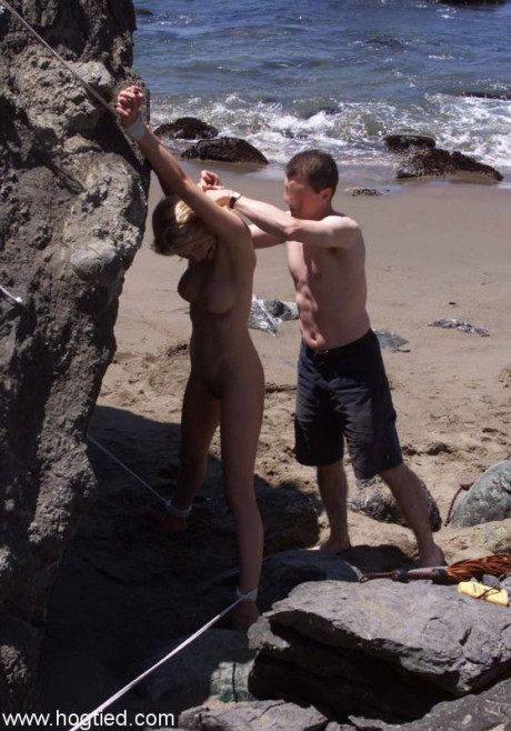 Nude old slave Sadie Belle gets tied to a enormous rock on the beach - #677759