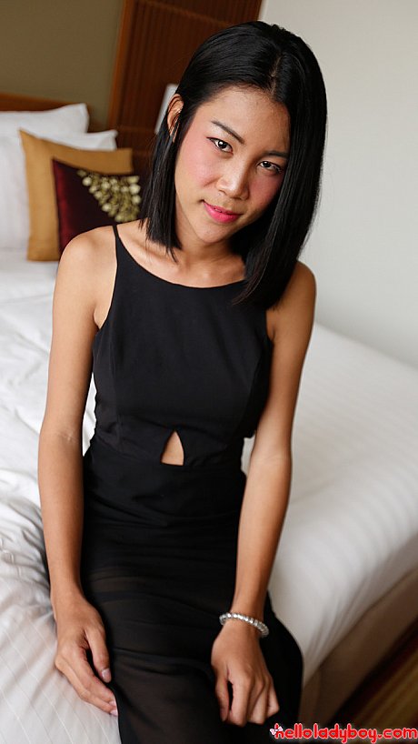 Pretty charming oriental t-girl shows her thin body in a pretty black dress & in fishnets - Gallery #30506