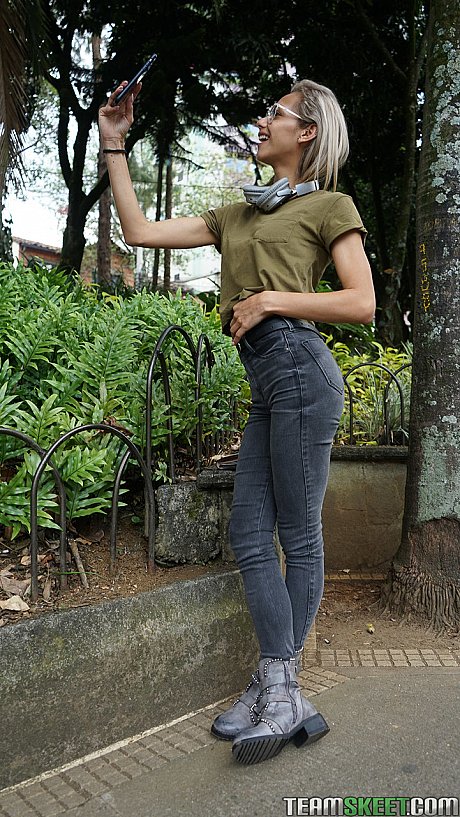 Veronica Leal posing all over her hood in green shirt and tight jeans - Image 9 of 16  in Outdoor category   featuring Veronica Leal 