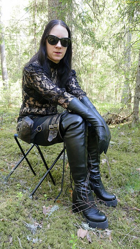 Clothed female wears leather gloves and boots plus shades in the woods - Image 3 of 16  in Close Up category  