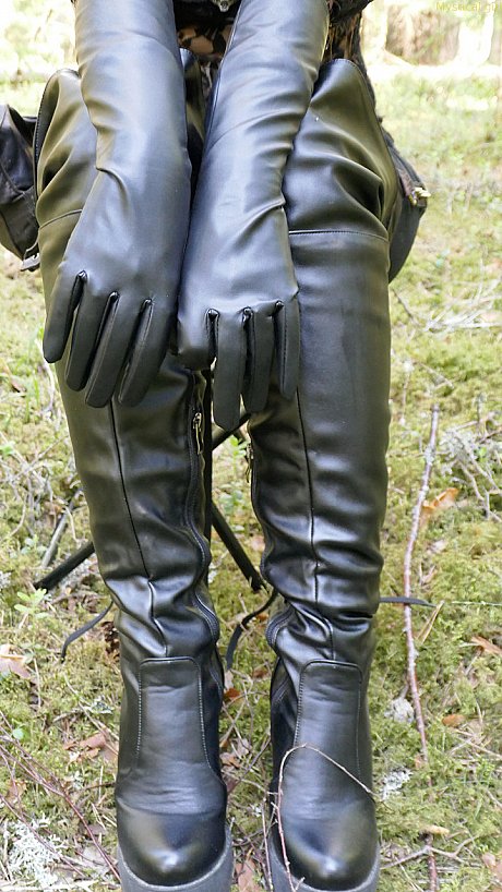 Clothed female wears leather gloves and boots plus shades in the woods - Image 6 of 16  in Close Up category  