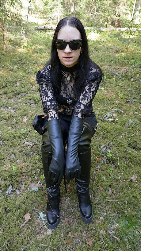 Clothed female wears leather gloves and boots plus shades in the woods - Image 11 of 16  in Close Up category  