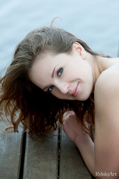 Euro model Ilze wears a smile on gorgeous pretty face during naked posing on dock - Image 11 of 16  in Close Up category   featuring Ilze 