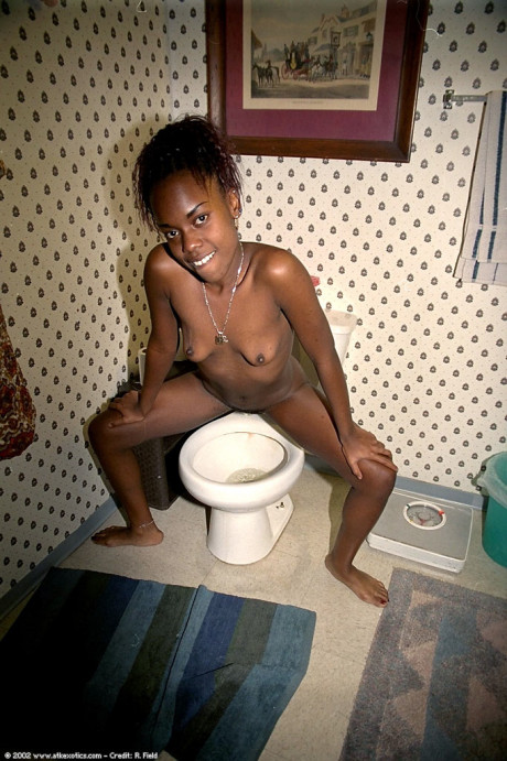 Petite ebony babe Jezebel takes a piss during a pretty striptease - #1228098