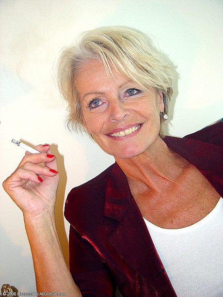 Mature chick lady Justine exposes her saggy tanned breasts while smoking a cigarette - Image 6 of 20  in Legs category   featuring Justine 